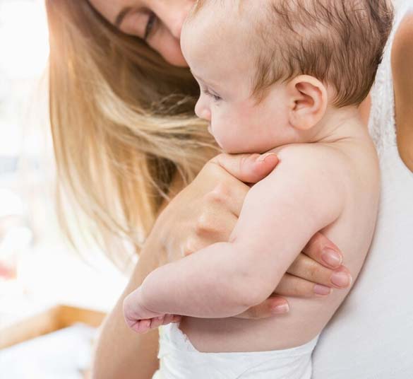 Mother holding infant for private BCG vaccination